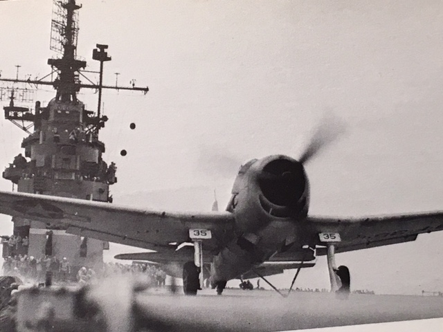 Propeller plane flying off of the flight deck of Intrepid.
